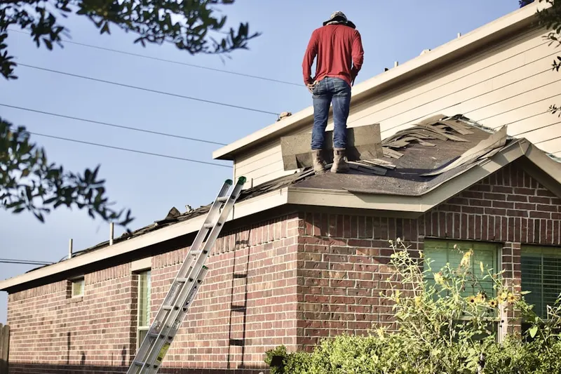 Professional roofer working on a residential roof in Talcottville